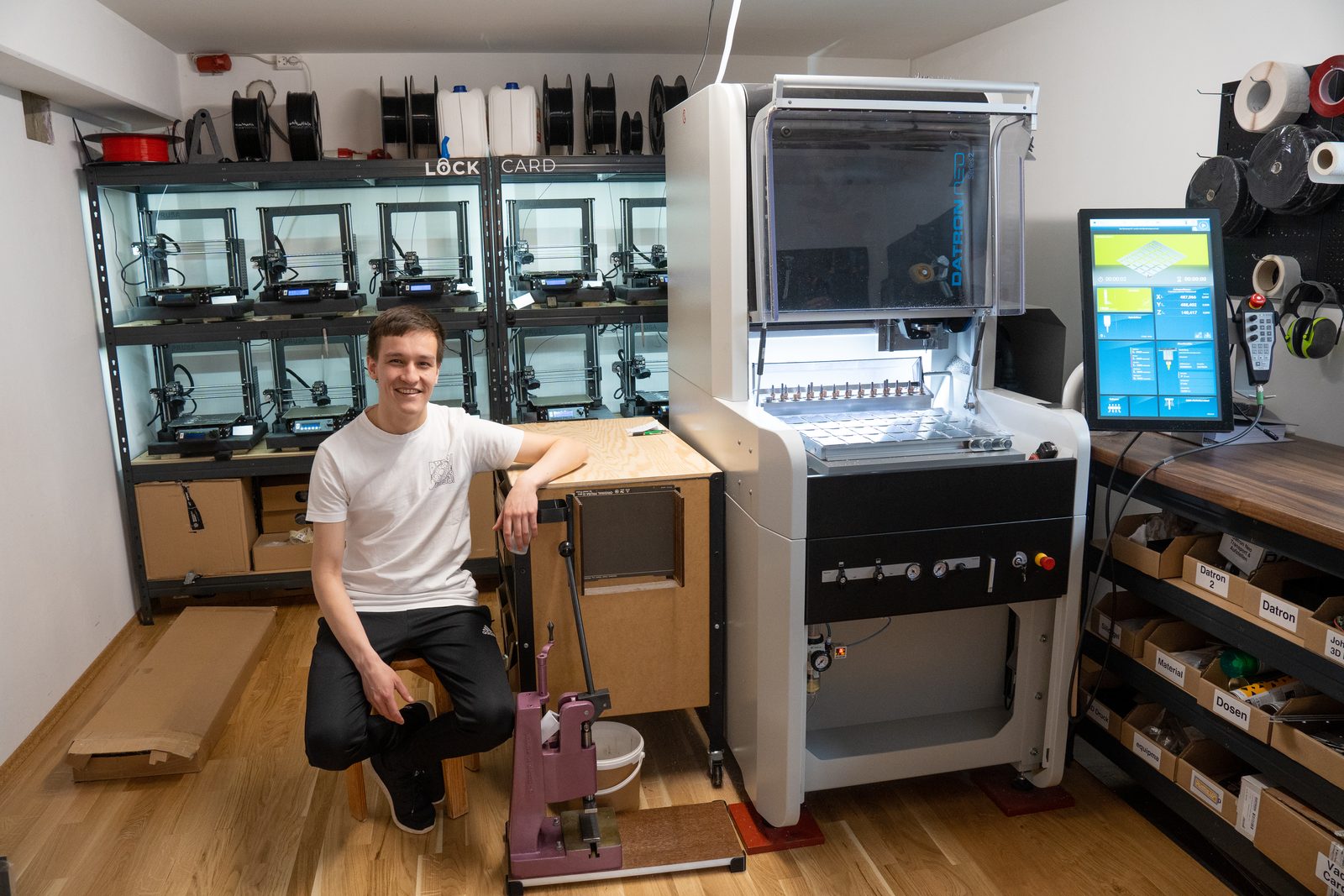 Aaron Rau next to a production machine